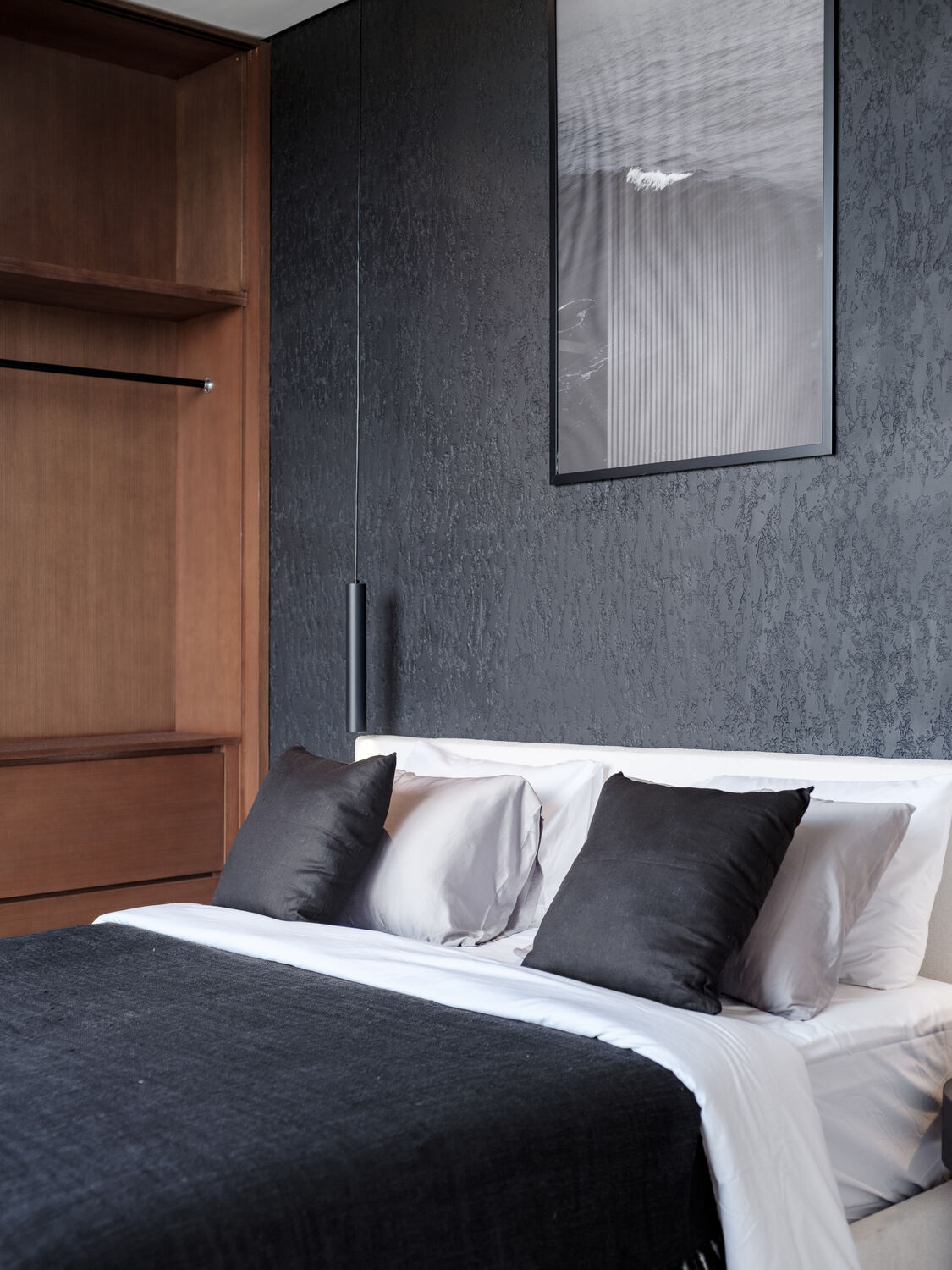Bedroom with dark feature wall and timber joinery